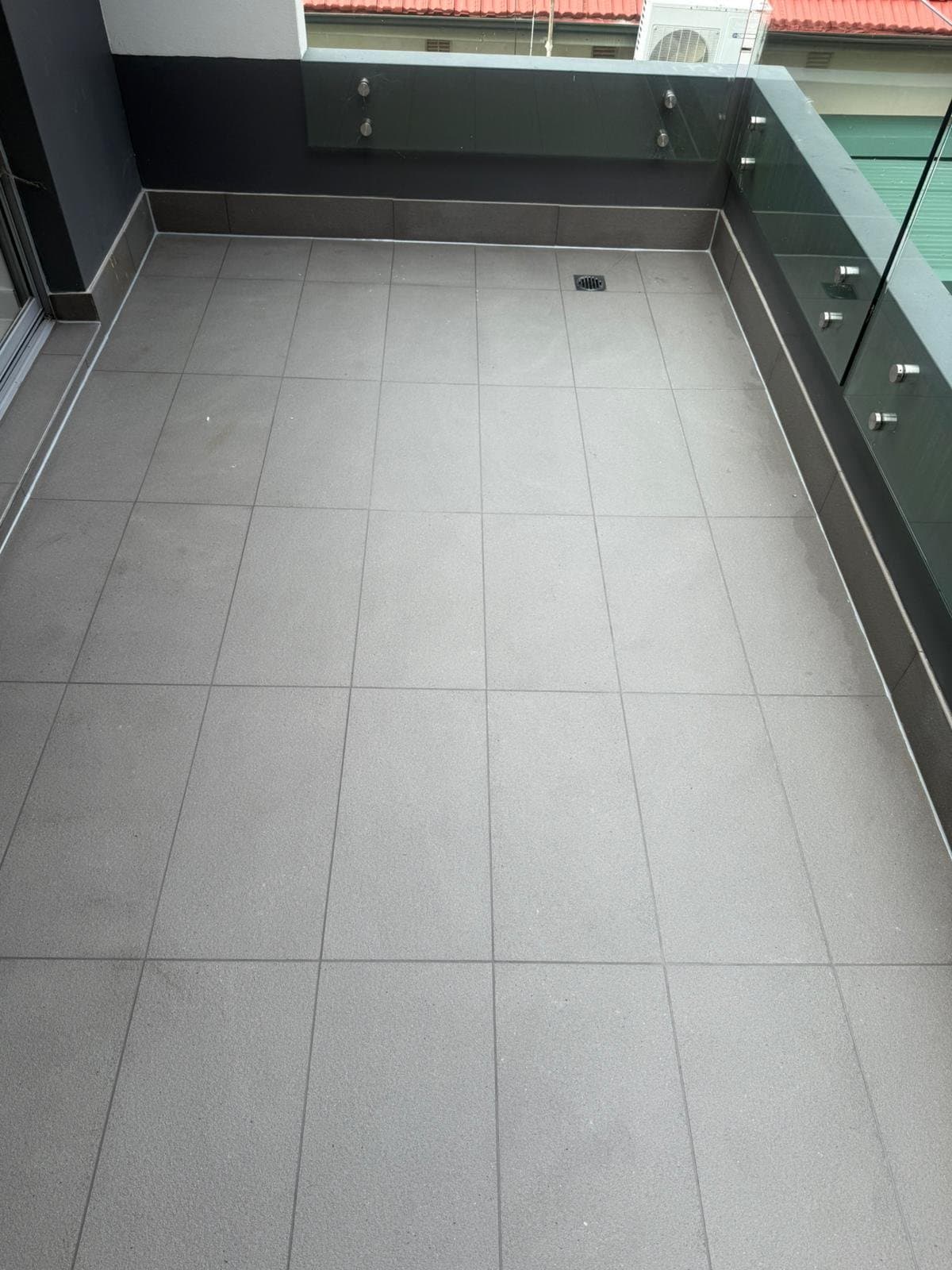 The same balcony tiles cleaned back and evenly coloured
