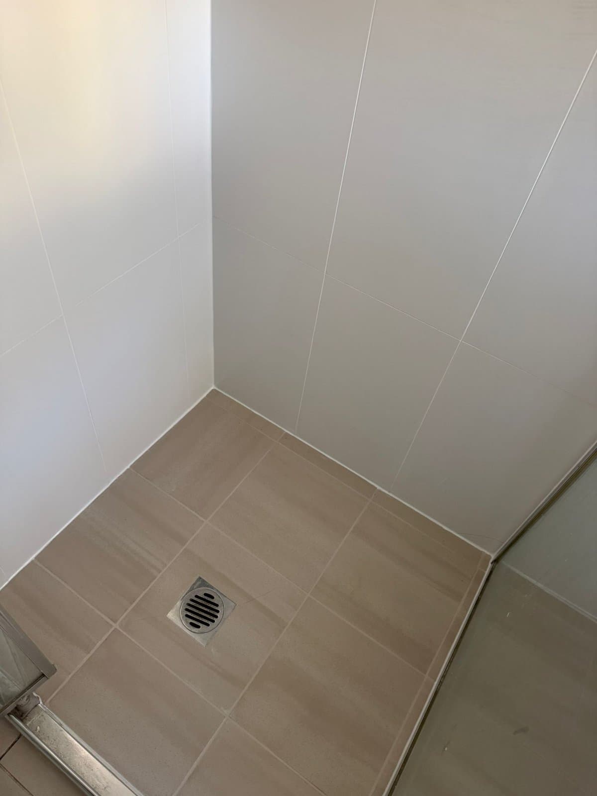 The same shower with the grout clean and the corner junction resealed