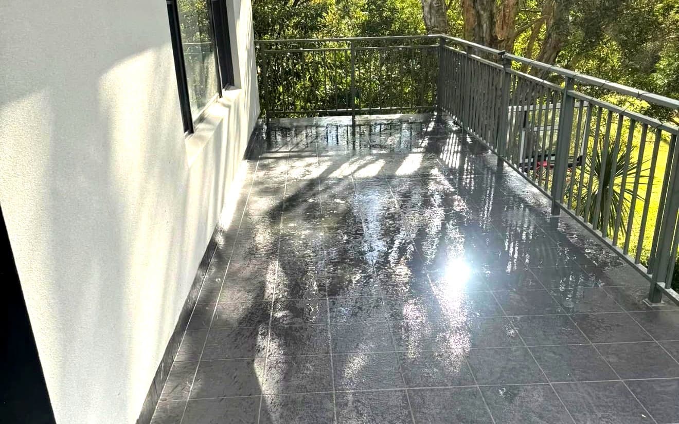 Water pooling on a tiled balcony in Sydney